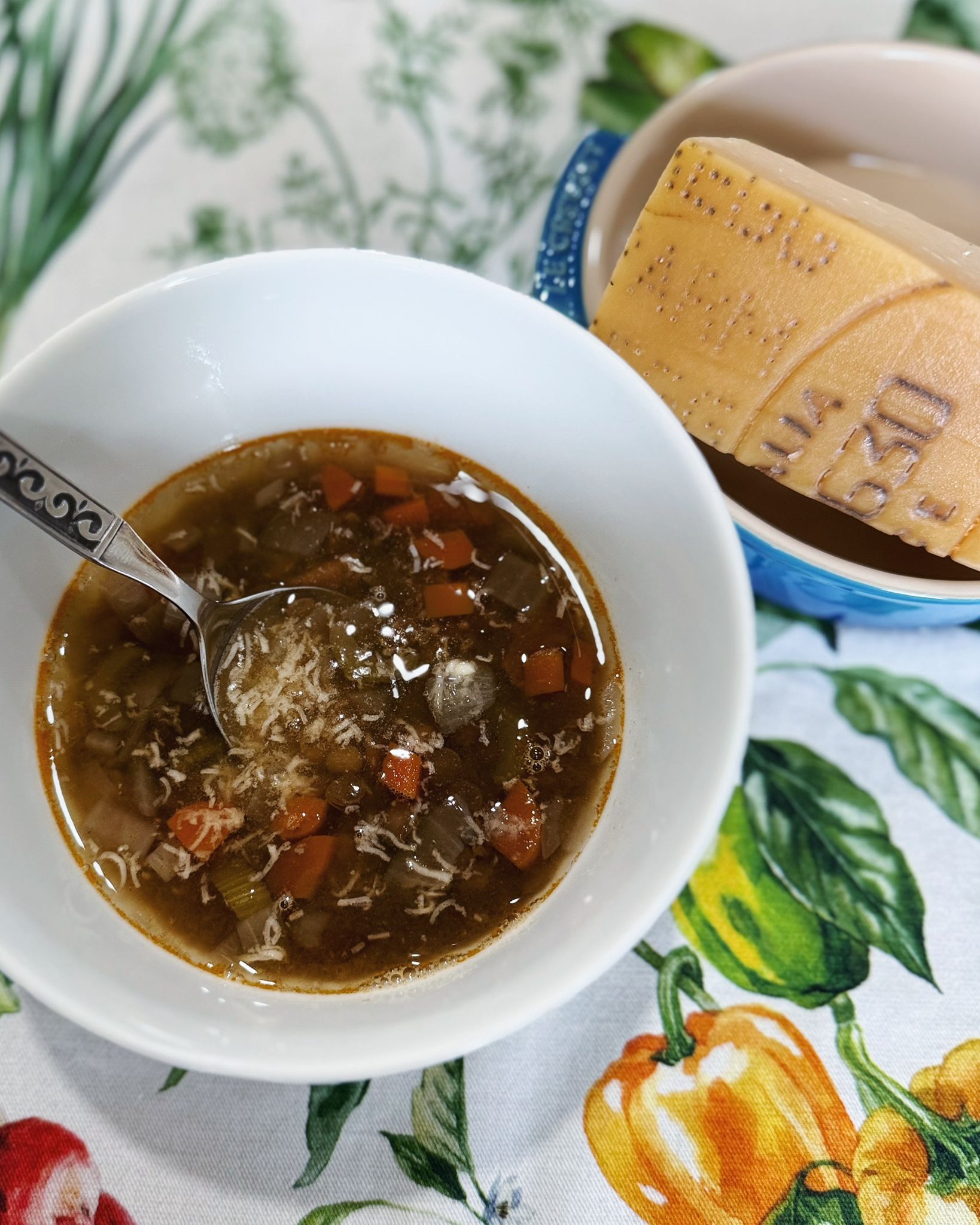 Bowl of lentil soup with authentic parmesan cheese